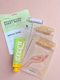 Collection of skincare products including a sheet mask, lip balm, and gloves